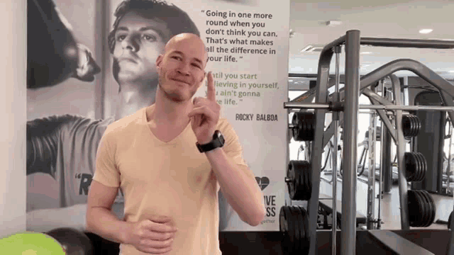 a man stands in front of a sign that says " going in one more round when you don t think you can "