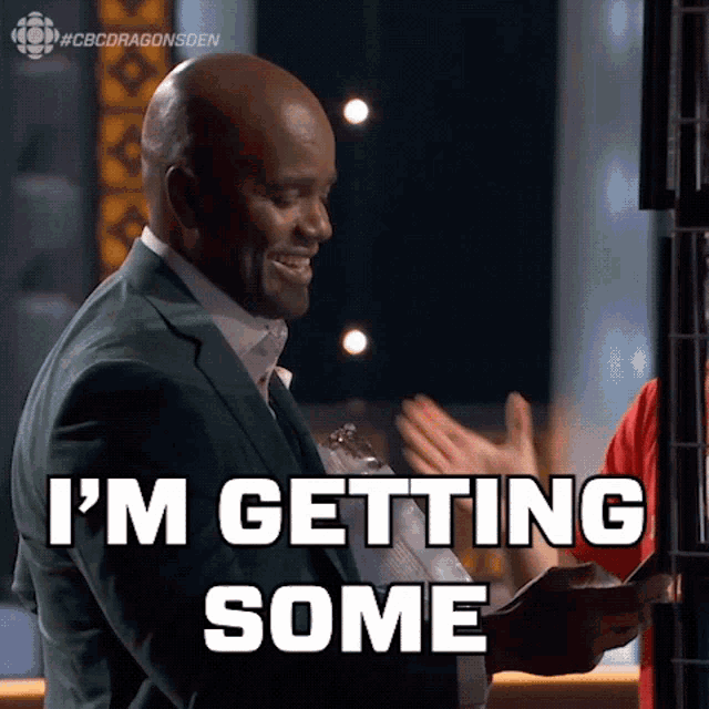 a man in a green suit says " i 'm getting some " while holding a piece of paper