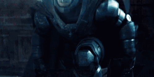 a man in a superman costume is flying through the air in a room .