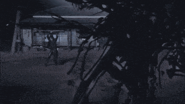 a man is holding a sword in the air in a dark room .