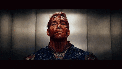 a man with blood on his face is looking up at the sky