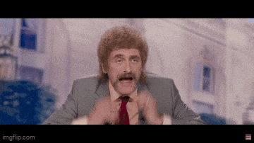 a man in a suit and tie is making a funny face