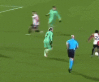 a soccer player with the number 20 on his jersey is being tackled by another player