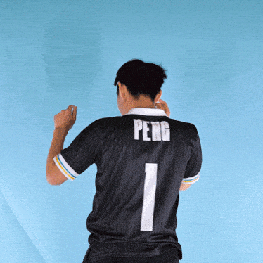 a person wearing a black shirt with the number 1 on it