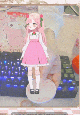 a person is holding a doll in front of a keyboard that says find my wishlist at throne.com