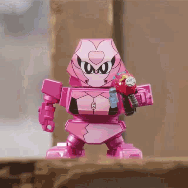 a pink robot with a heart on its head is holding a sword