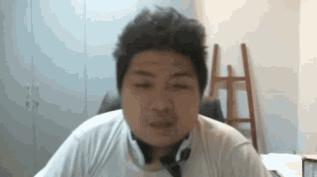 a man wearing headphones and a white shirt looks at the camera .
