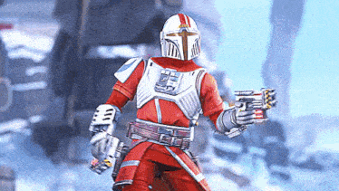 a man in a red and white armor is holding a gun in his hands .