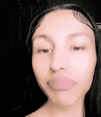 a close up of a woman 's face with pink lips