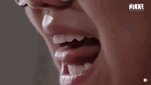 a close up of a person 's mouth with their tongue out