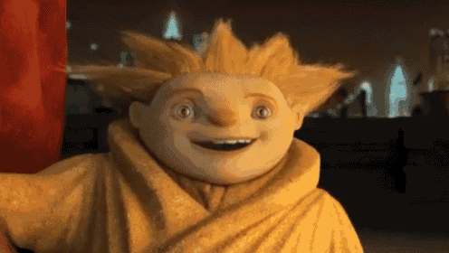 a cartoon character is wearing a yellow robe and smiling for the camera