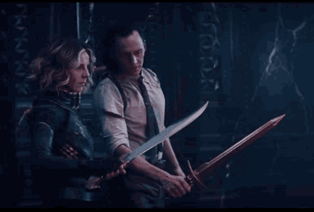 a man and a woman are standing next to each other holding swords .