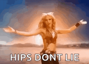 a woman is standing in the desert with her arms outstretched and says hips dont lie