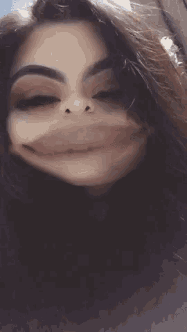 a close up of a woman making a funny face with her mouth wide open