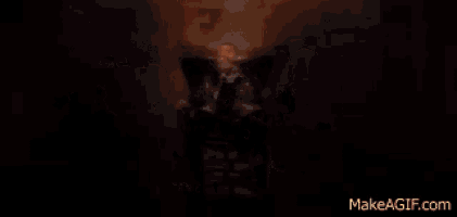 a dark room with a reflection of a person 's face in the window .