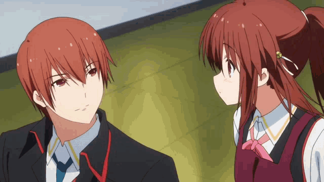 a boy and a girl are looking at each other and the girl has a ponytail