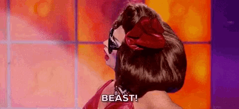 a drag queen is wearing a red dress and sunglasses and says beast .