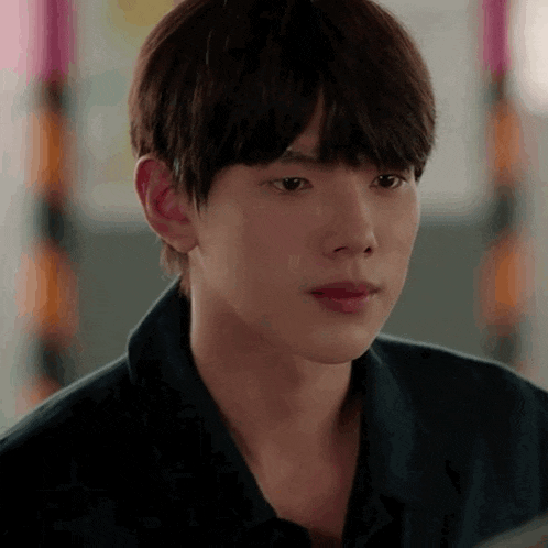 a close up of a young man 's face while looking at something .