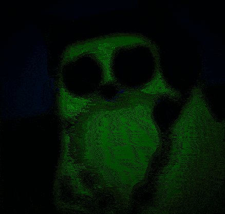 a green glowing skeleton is sitting in the dark .