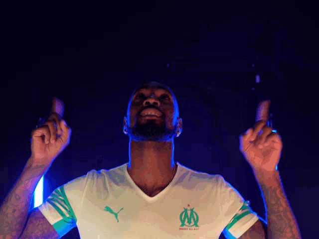 a man wearing a white shirt with a puma logo on it