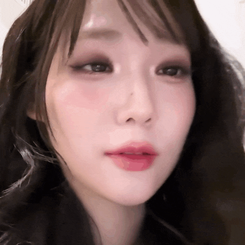 a close up of a woman 's face with long hair