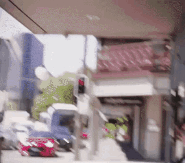 a blurry picture of a street with a red traffic light