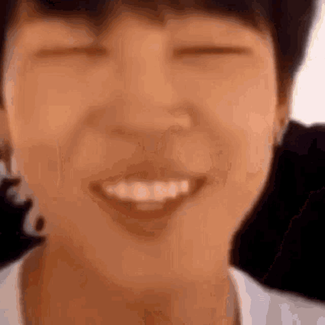 a close up of a person 's face with their eyes closed and their mouth open .