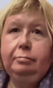 a close up of a woman 's face with a serious look on her face .