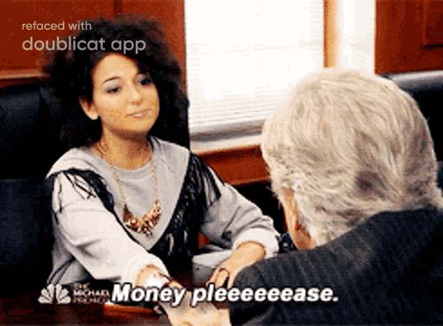 a woman sitting at a table talking to a man who says money pleeeease