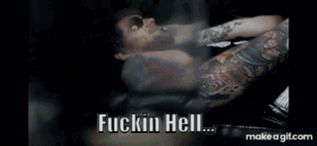 a man wearing sunglasses is smoking a cigarette and saying fuckin hell