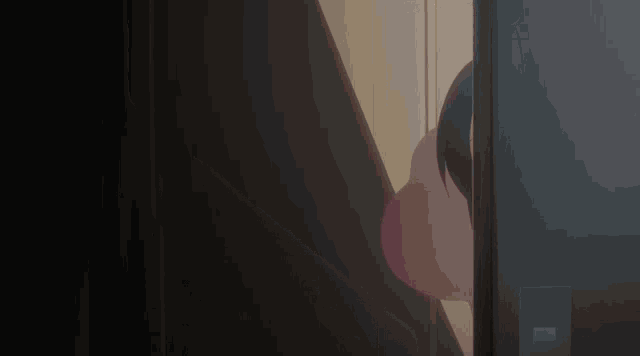 a girl with a skull on her head looks out of a doorway