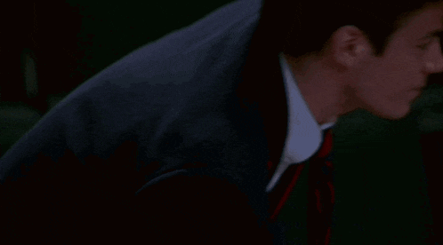a man wearing a suit and tie with red stripes