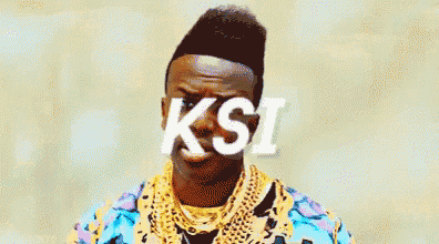 a man wearing a colorful jacket and gold chains is making a funny face with the word ksi on his face .