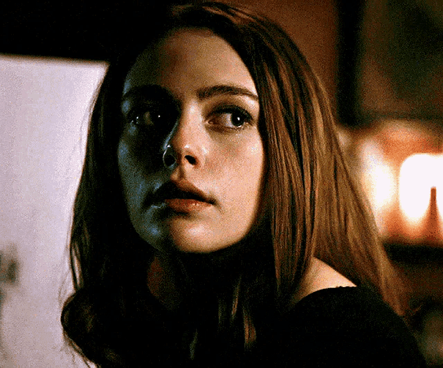 a close up of a woman 's face with a serious look on her face