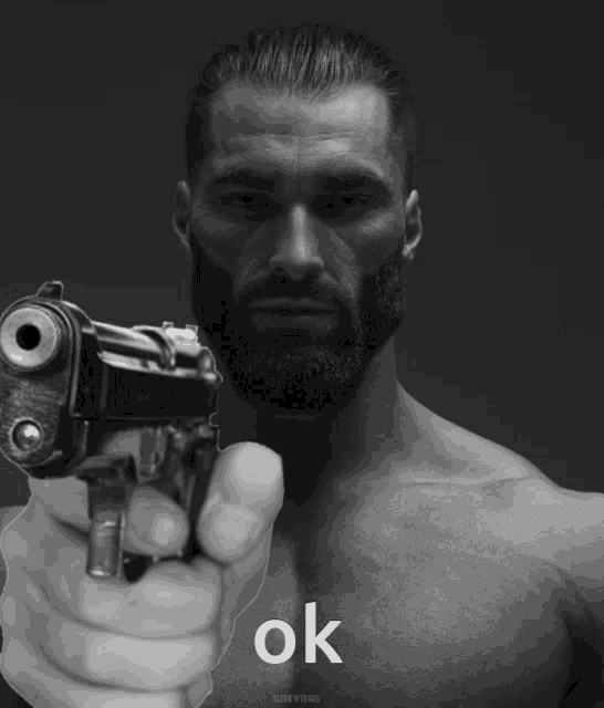 a man with a beard is pointing a gun at the camera with the word ok written below him