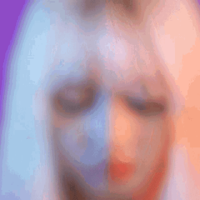 a close up of a woman 's face with blonde hair and red lips