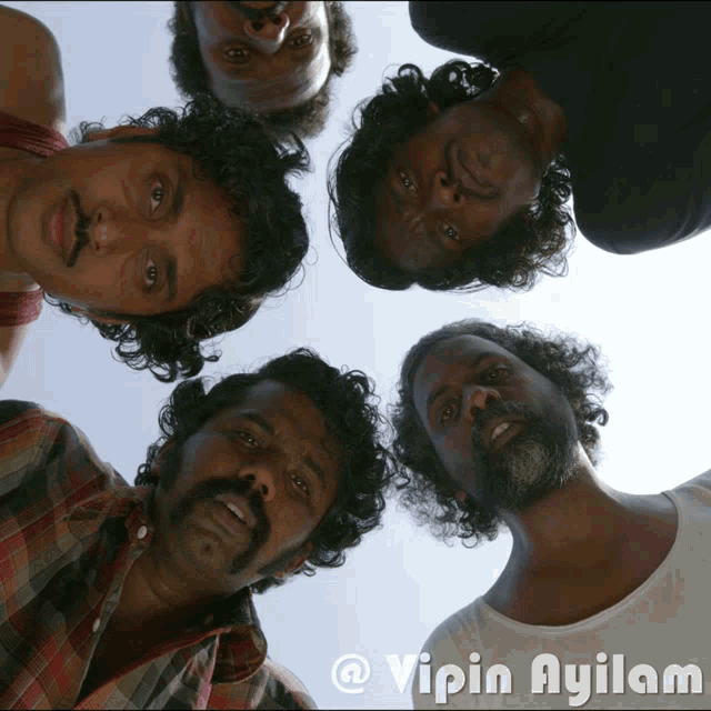 a group of men are looking up at the camera with the name vipin ayilam on the bottom