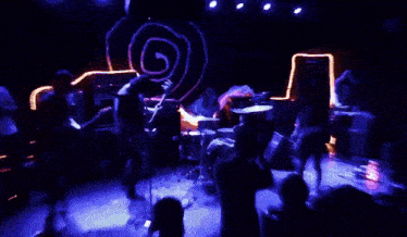 a person is playing drums in a dark room