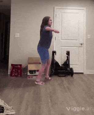 a girl is jumping in front of a stroller in a living room with the words vigle.ai below her