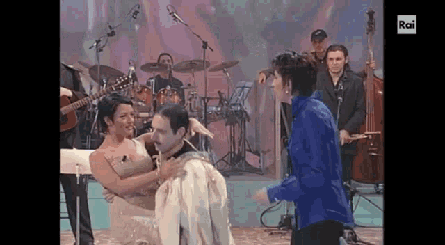 a man and a woman are dancing in front of a band and the words rai are on the bottom