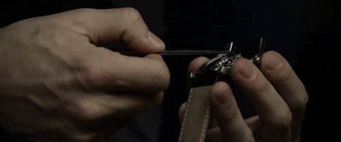 a close up of a person 's hands holding a watch