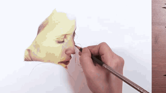 a person is drawing a picture of a woman 's face with a pencil .