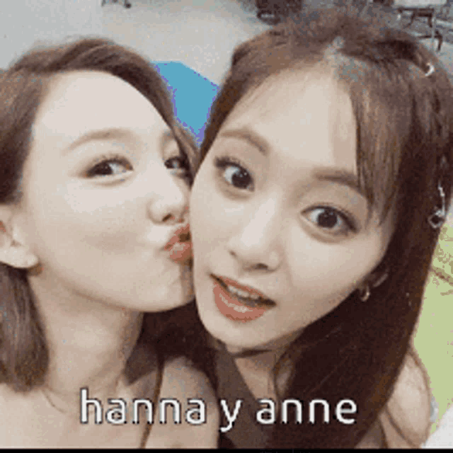 two women are kissing each other and the words hanna y anne are above them