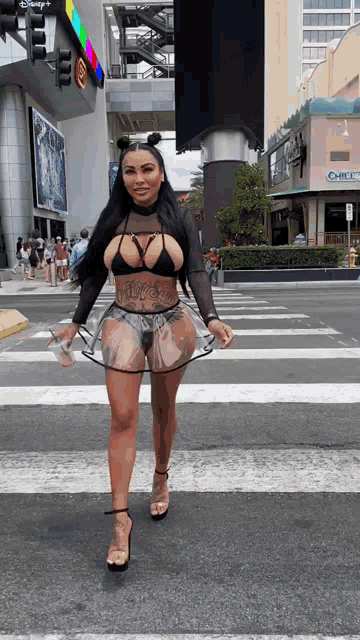 a woman is crossing the street in front of a building that says office