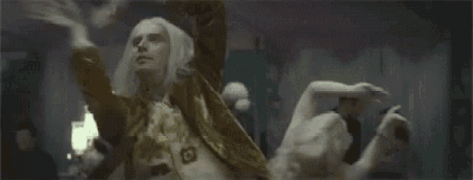 a group of people are dancing in a room .