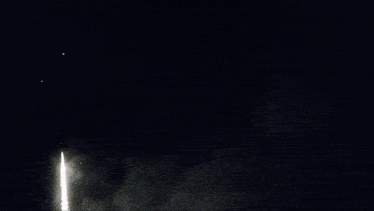 fireworks are displayed in the night sky with smoke coming from them