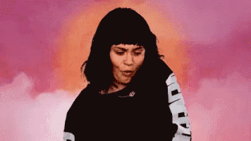 a pixelated image of a woman wearing a black sweatshirt with the letter r on the sleeves ..