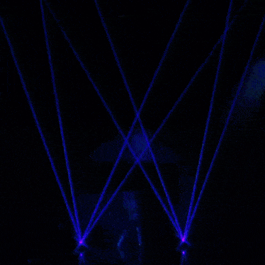 a silhouette of a person is projected on a large screen surrounded by blue lights