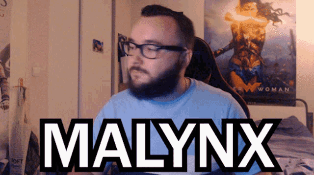 a man with glasses and the name malynx on the bottom