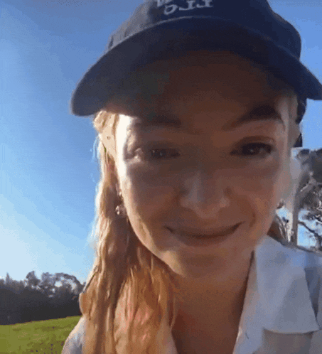 a woman wearing a blue hat that says o.j.t. on it